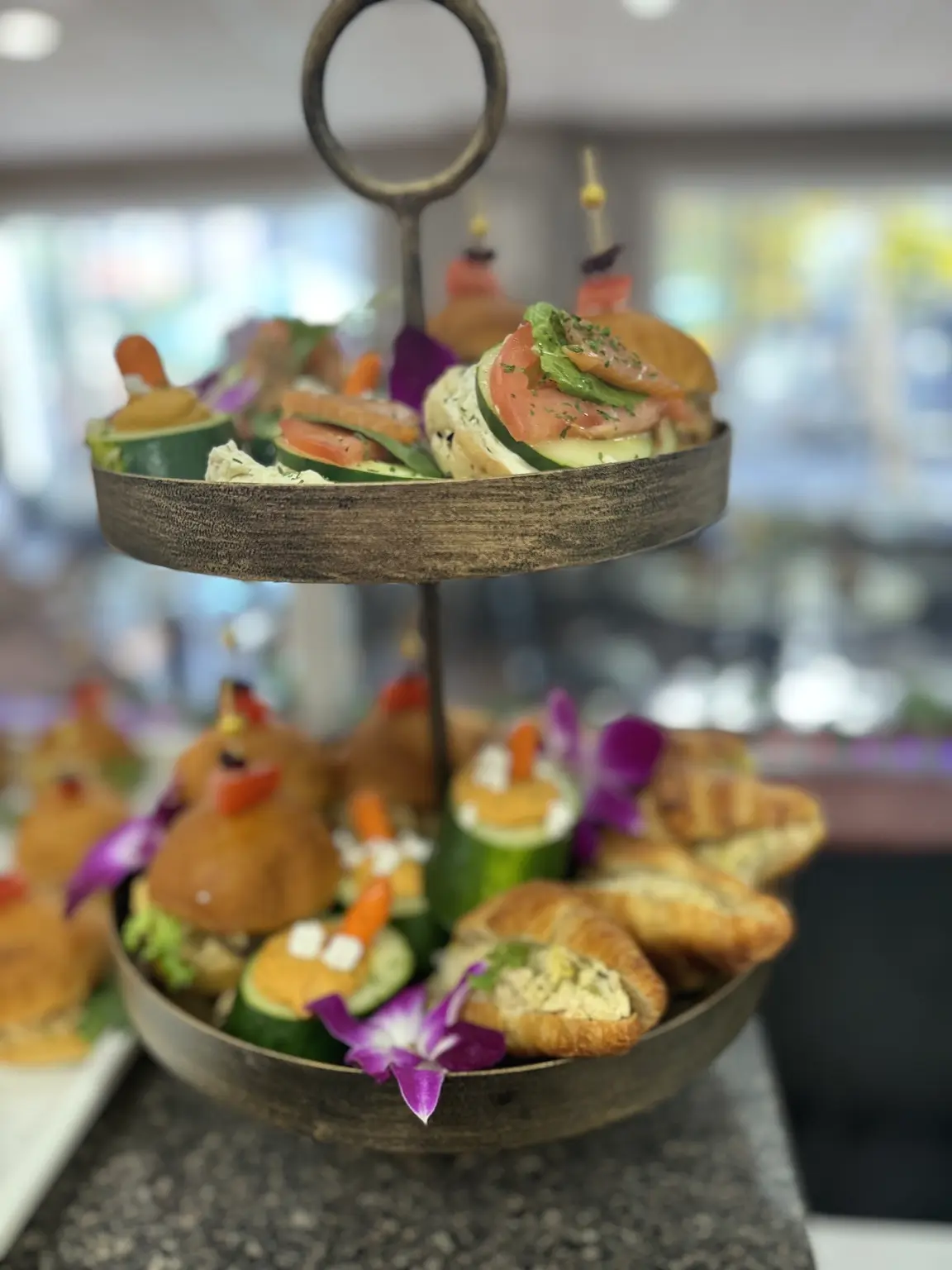 Crave tiered savory stand with tea sandwiches, croissants and floral details