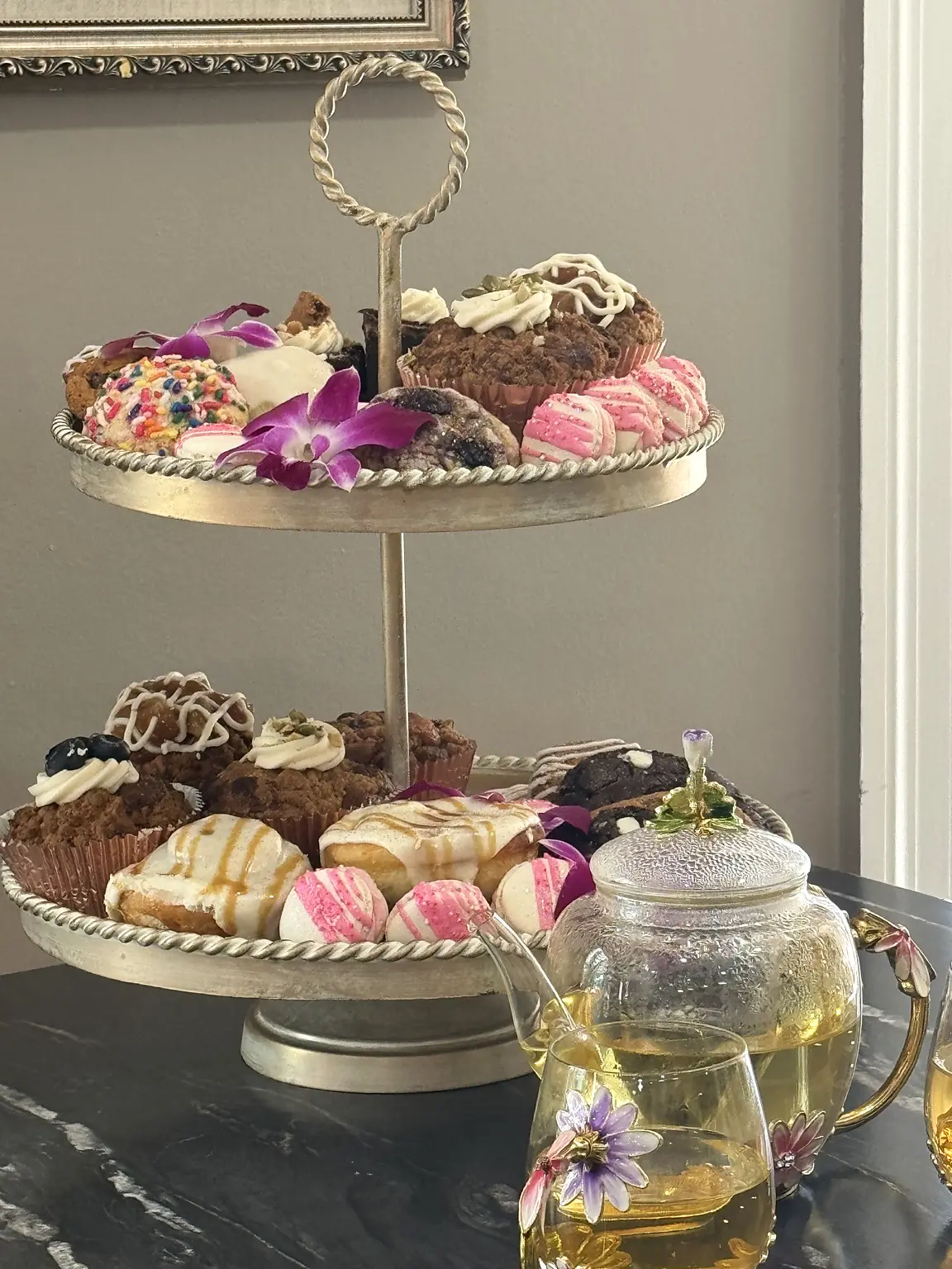 Tiered display of scratch-made Crave pastries, macarons and muffins
